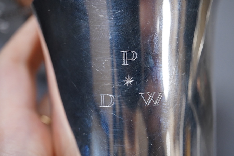 An Elizabeth II silver beaker, with engraved initials, makers TW over BD, London, 1992, 87mm, together with a 1920's hammered Danish white metal beaker and a 19th century French 950 standard white meal beaker, 9.8oz.
